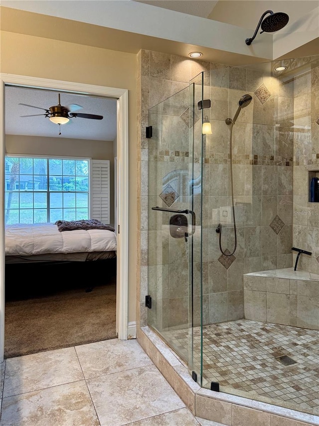 bathroom featuring an enclosed shower and ceiling fan