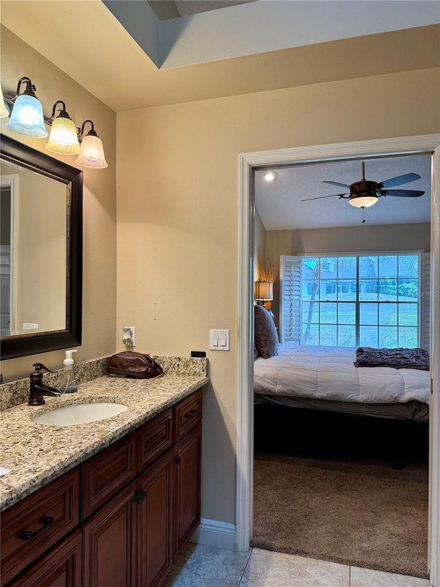 bathroom with ceiling fan, vanity, and tile patterned flooring