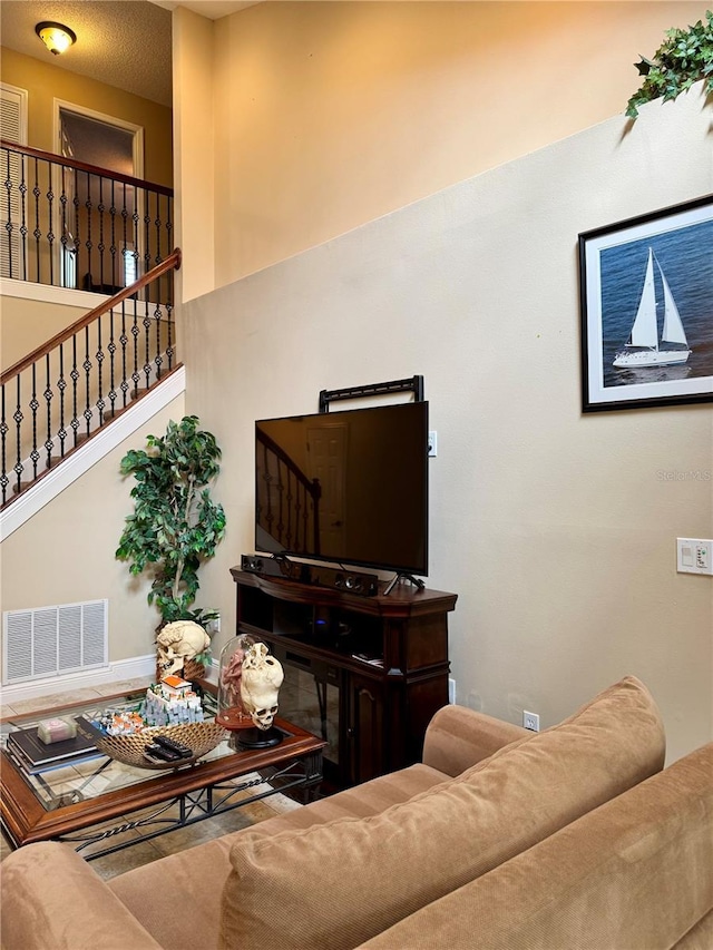 living room with a towering ceiling