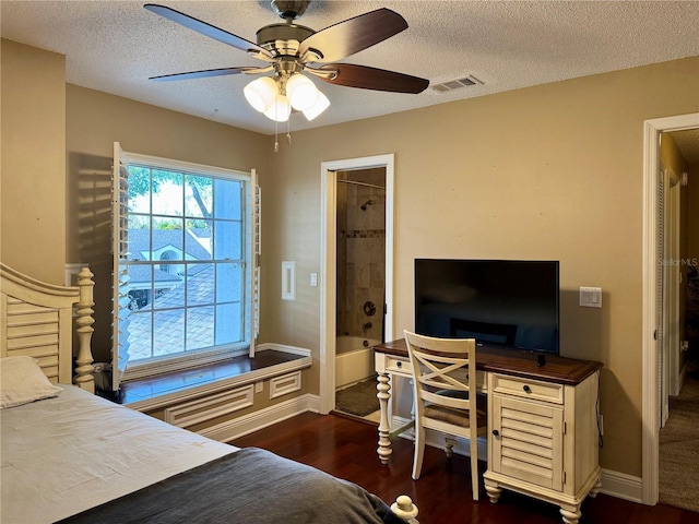 bedroom with ceiling fan, dark wood-type flooring, and a textured ceiling