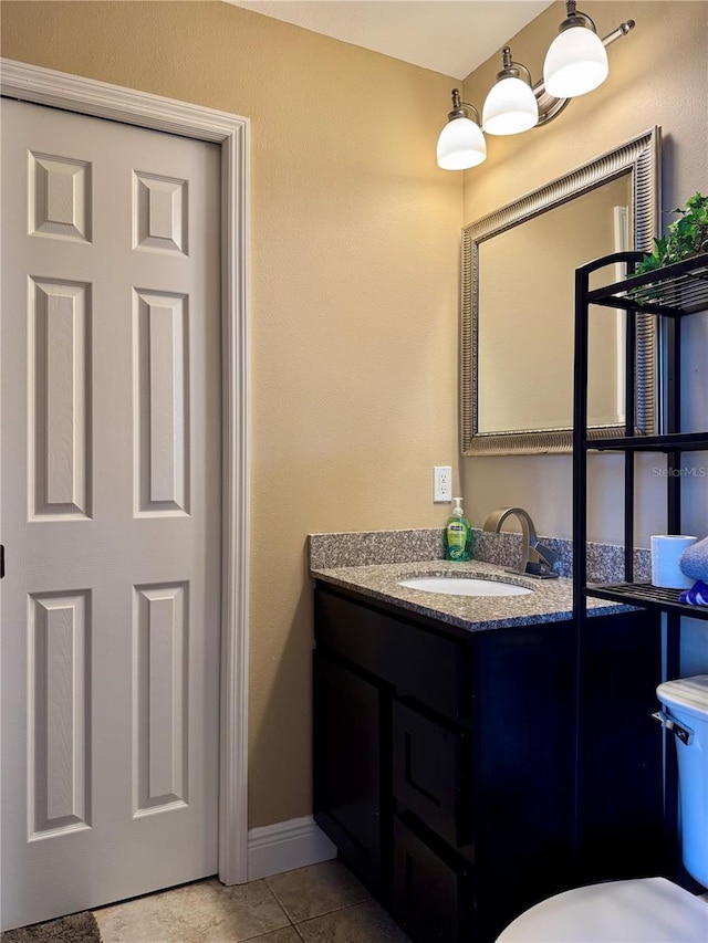 bathroom featuring tile patterned floors, vanity, and toilet