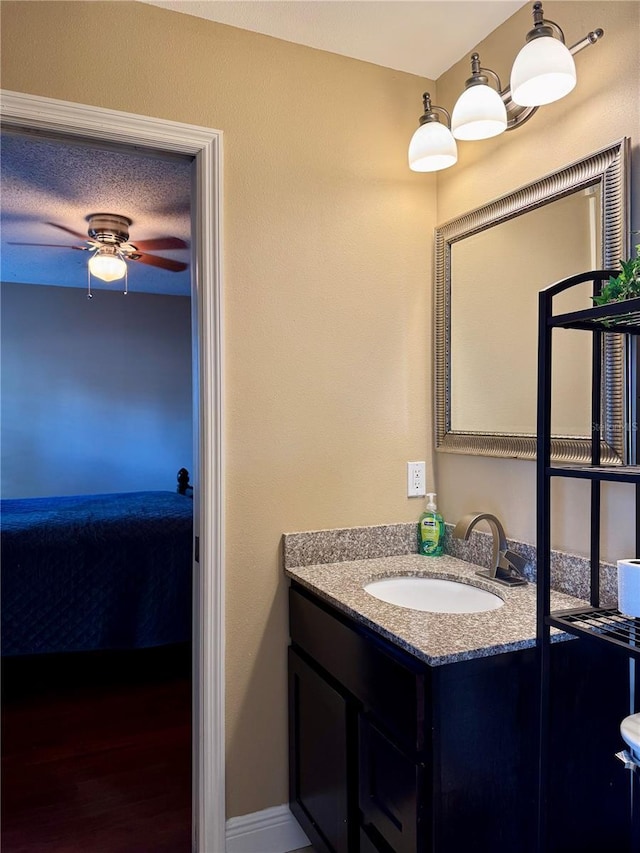 bathroom featuring vanity, a textured ceiling, and ceiling fan