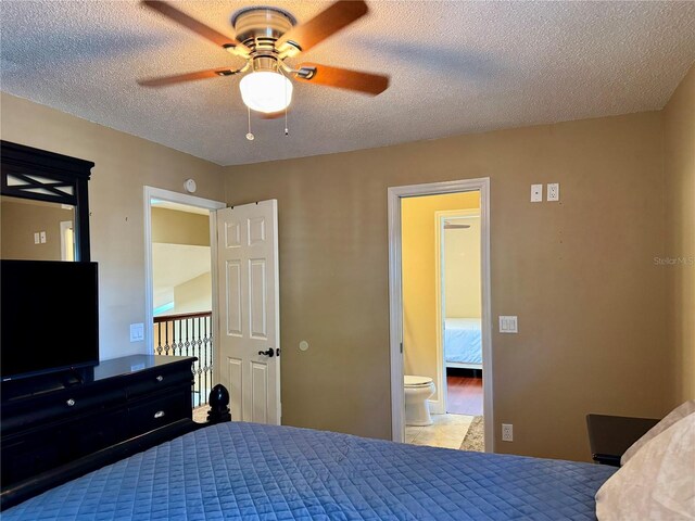 bedroom with ceiling fan and a textured ceiling