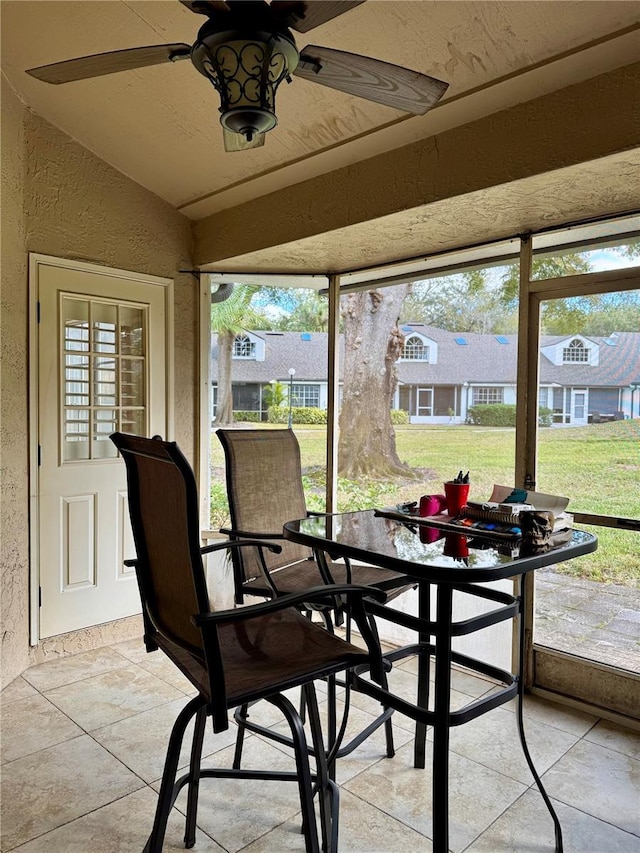 sunroom / solarium with ceiling fan and lofted ceiling