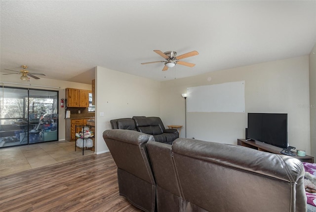 living room featuring ceiling fan and wood-type flooring