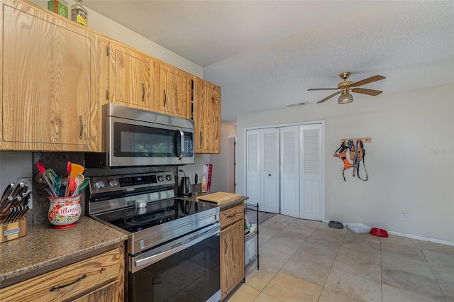 kitchen featuring stainless steel appliances, ceiling fan, a textured ceiling, and light tile patterned flooring