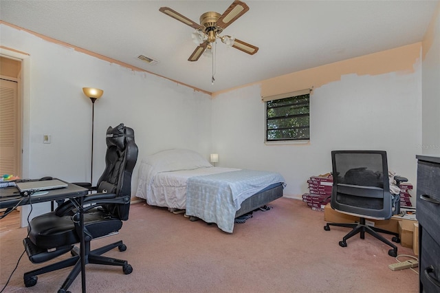 carpeted bedroom featuring ceiling fan and crown molding