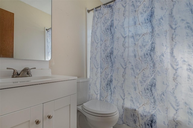 bathroom featuring toilet and vanity