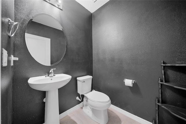 bathroom featuring tile patterned floors and toilet