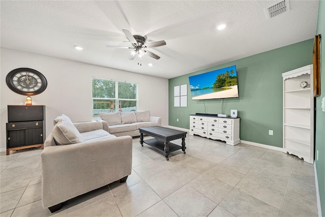 tiled living room with ceiling fan and a textured ceiling