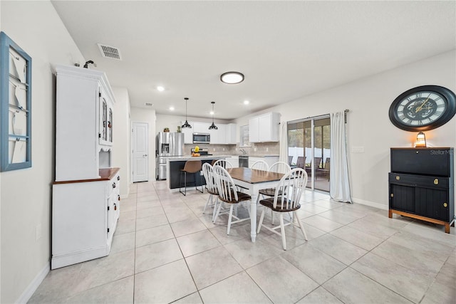 dining space featuring light tile patterned floors