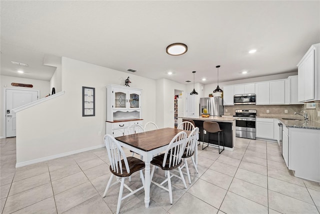 dining area with sink and light tile patterned floors