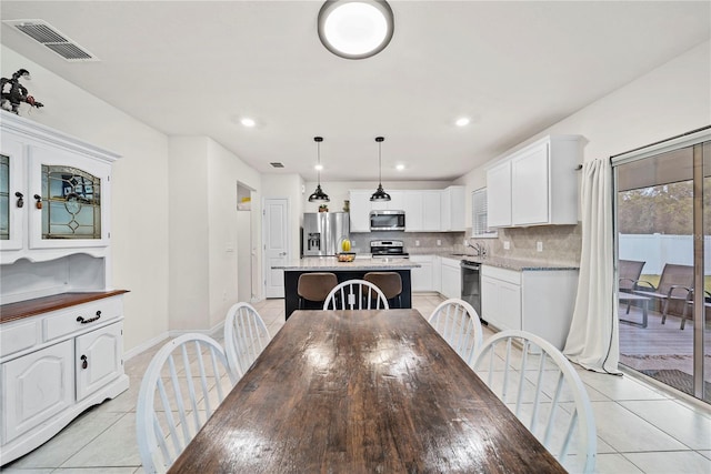 dining room with light tile patterned flooring and sink