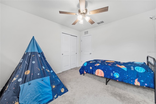 carpeted bedroom featuring a closet and ceiling fan