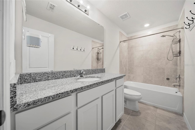 full bathroom with tile patterned flooring, vanity, toilet, and tiled shower / bath