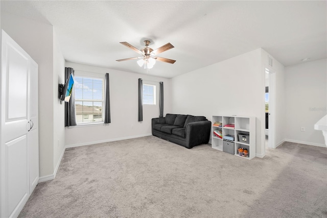 living room featuring ceiling fan and light carpet