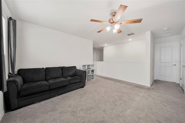 living room with ceiling fan and light colored carpet