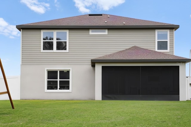 rear view of property featuring a yard