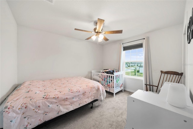 bedroom with light colored carpet and ceiling fan