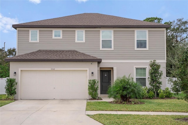 view of front of house featuring a garage and a front yard