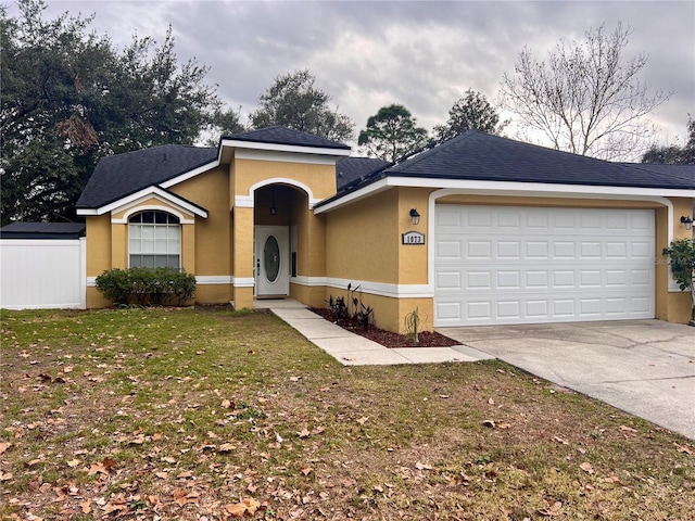 ranch-style home with a front yard and a garage