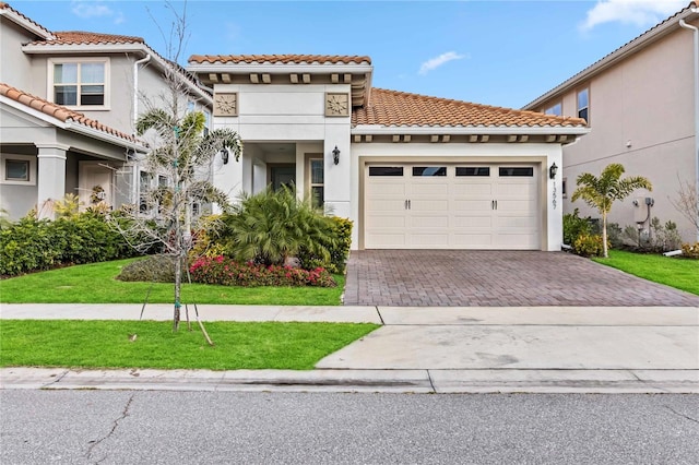 mediterranean / spanish house with a garage and a front yard