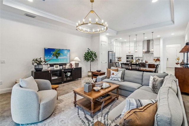 living room with a raised ceiling, a chandelier, and crown molding