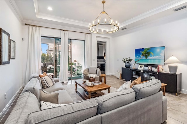 living room with a notable chandelier, crown molding, and a raised ceiling