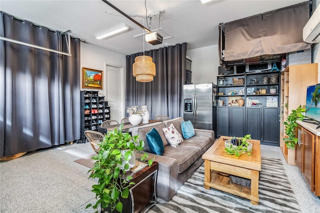 living room featuring an AC wall unit