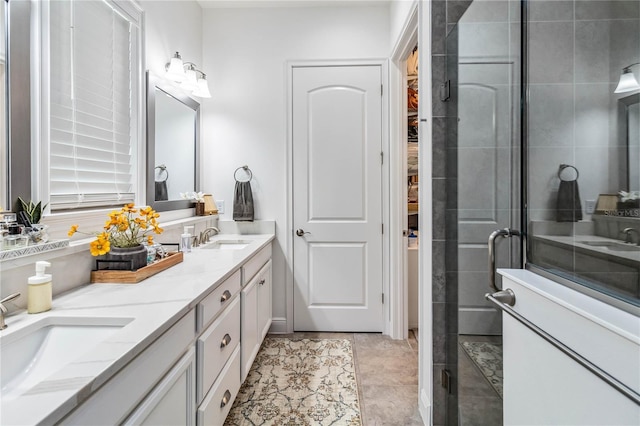 bathroom featuring an enclosed shower and vanity