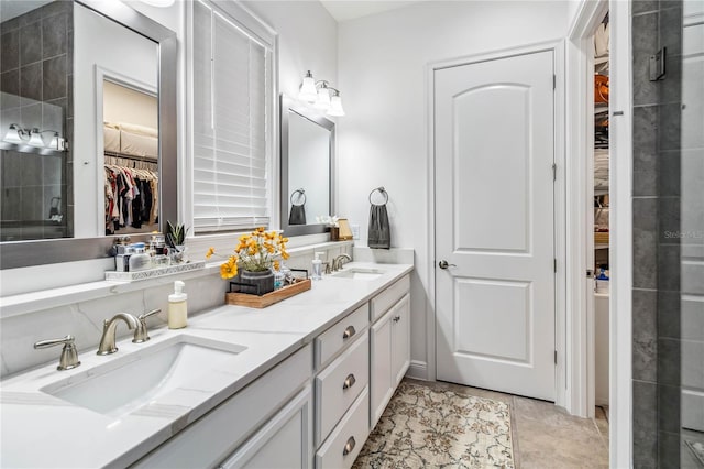 bathroom featuring tile patterned flooring, vanity, and a shower with shower door