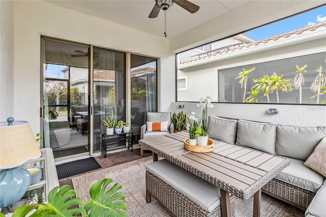 sunroom featuring ceiling fan