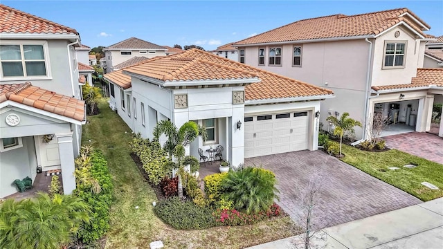 mediterranean / spanish-style home with a garage and a front lawn