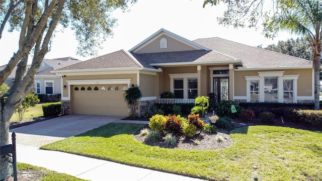 view of front facade with a front yard, a garage, and a porch