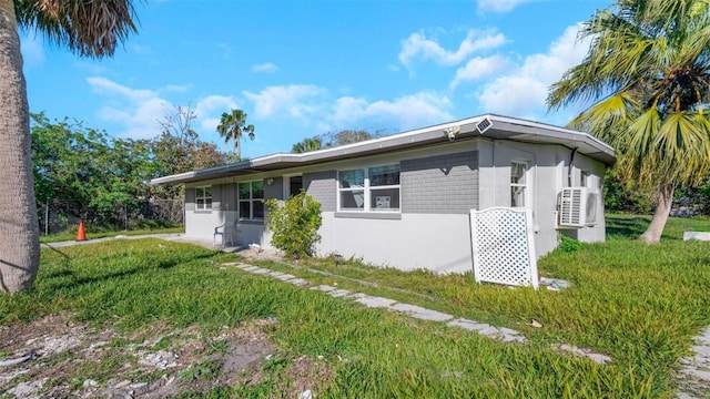 ranch-style home with a front lawn