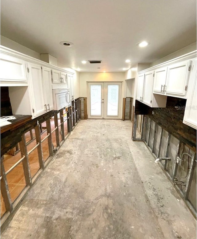 interior space featuring white cabinetry and french doors