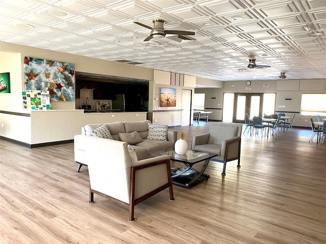 living room featuring ceiling fan and hardwood / wood-style floors