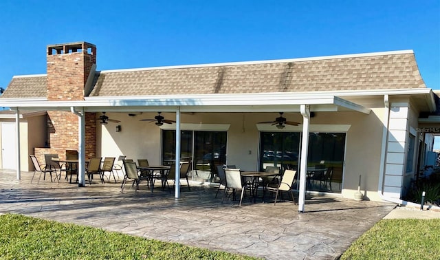 rear view of house featuring ceiling fan and a patio