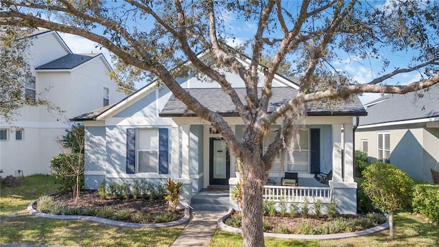 view of front of property with a front lawn and a porch