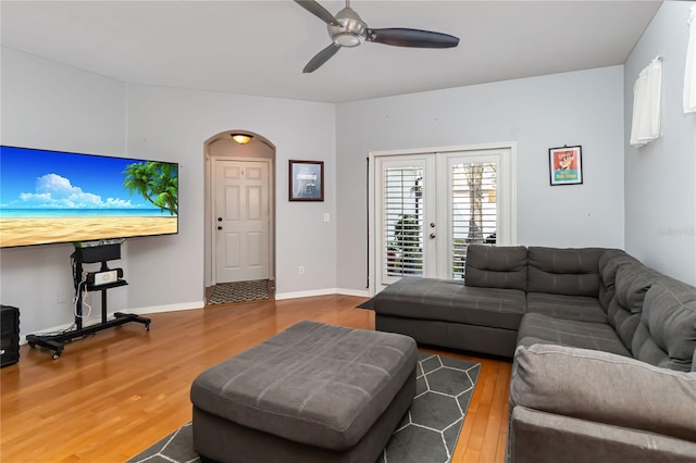 living room with hardwood / wood-style flooring, ceiling fan, and french doors