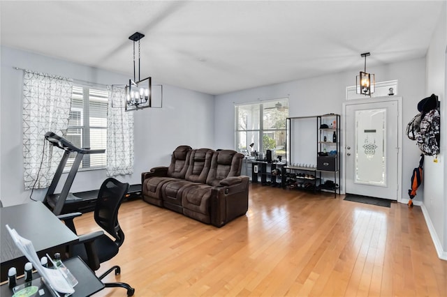 living room featuring hardwood / wood-style flooring and an inviting chandelier