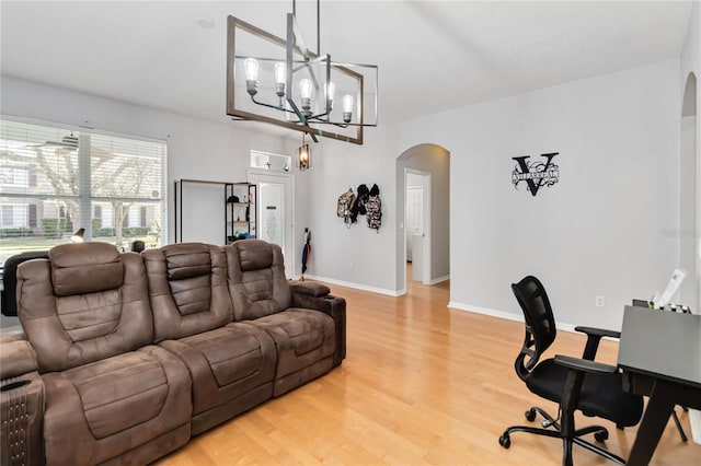 living room featuring wood-type flooring and an inviting chandelier