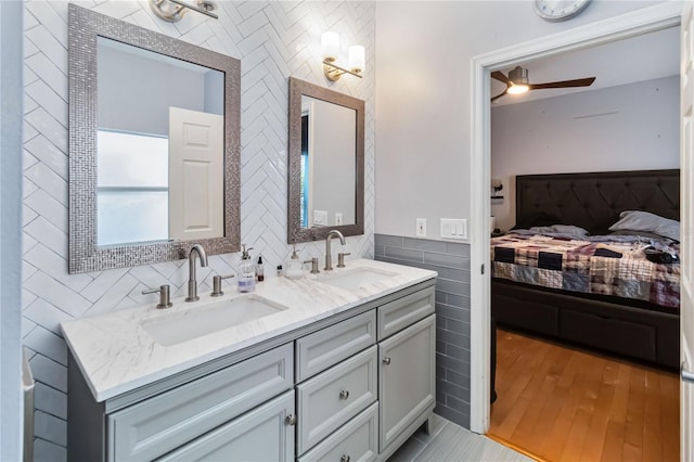 bathroom featuring tile walls, vanity, and ceiling fan