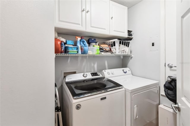 washroom featuring cabinets and separate washer and dryer