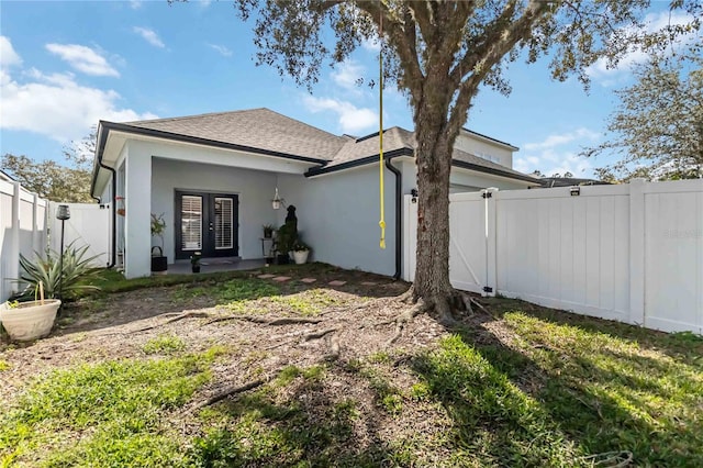 rear view of property featuring french doors