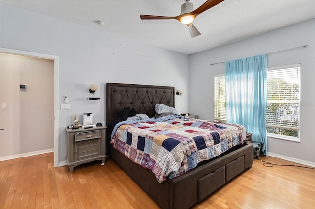 bedroom with ceiling fan and light hardwood / wood-style floors