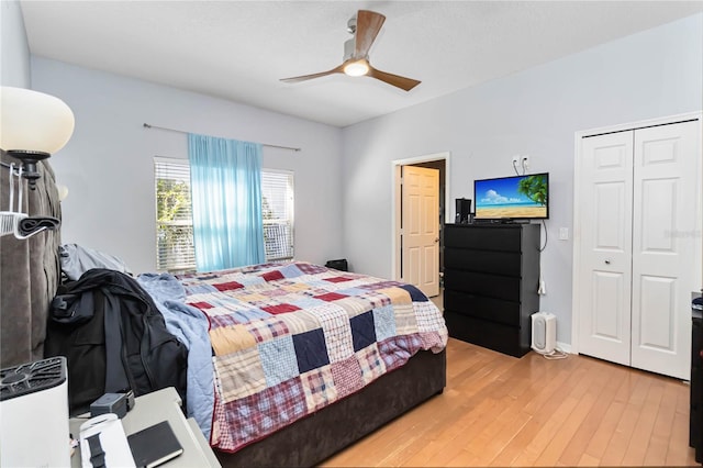 bedroom with hardwood / wood-style flooring, ceiling fan, and a closet