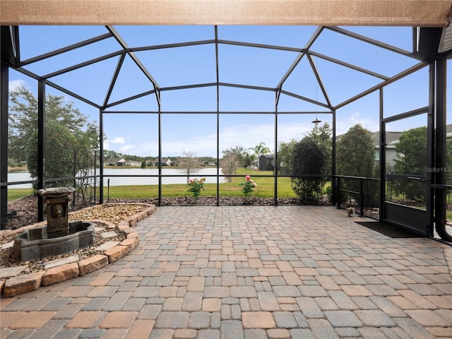 view of patio / terrace with a water view and glass enclosure