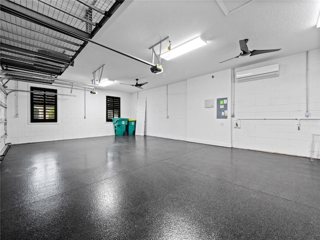 garage with a garage door opener, a wall unit AC, electric panel, and ceiling fan