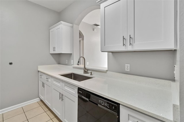 kitchen with light stone countertops, sink, white cabinets, and black dishwasher